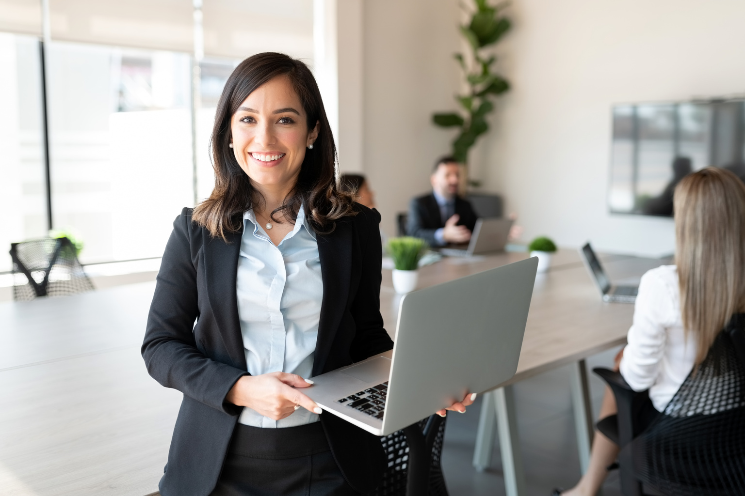 Woman with a laptop in a meeting room