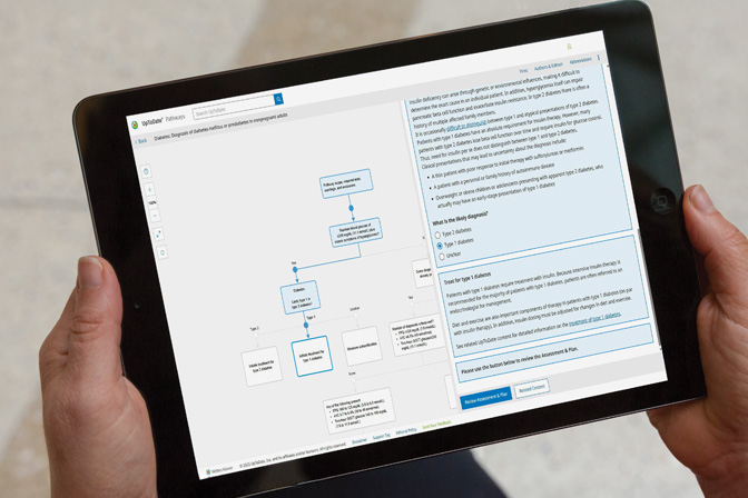 hands holding a tablet displaying information